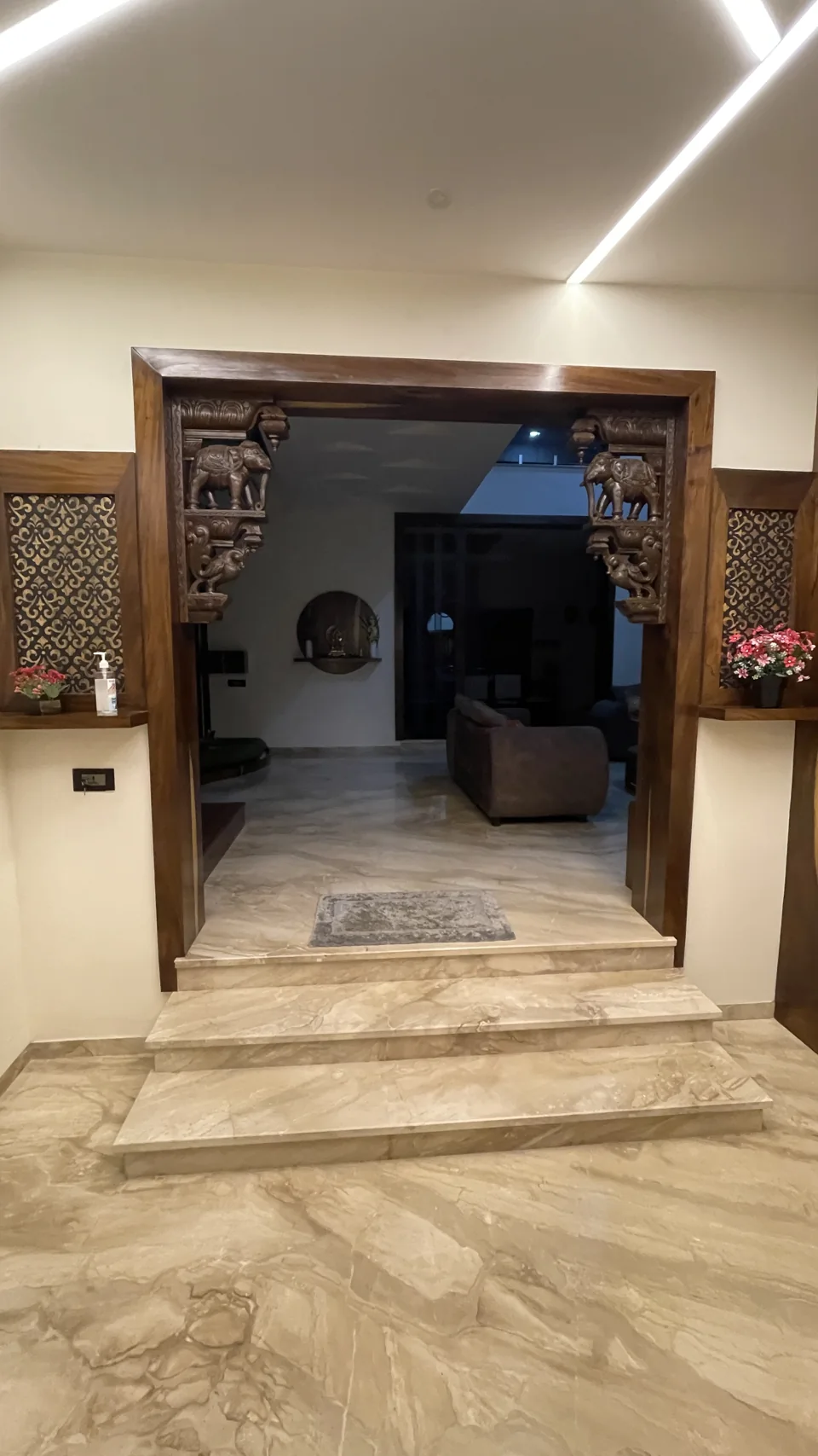 Marble entrance steps leading through a timber doorway into the living room